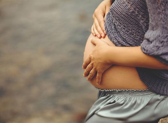 pregnant lady holding stomach